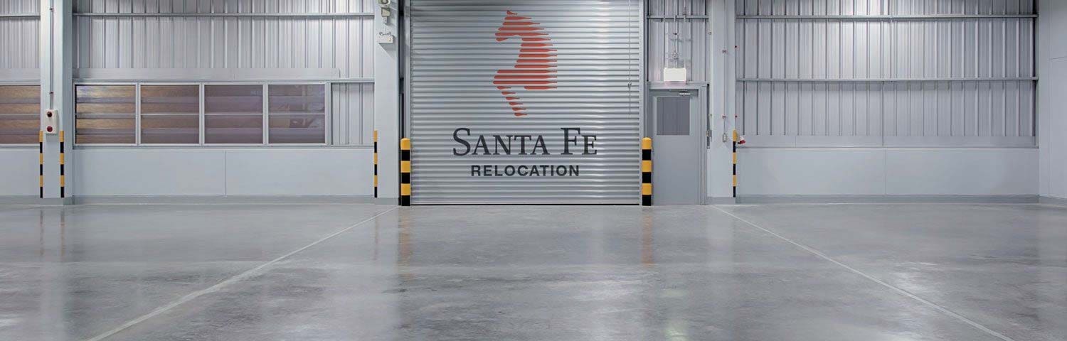 interior shot of a Santa Fe storage facility, showing a large open space and the Santa Fe logo on a large shutter door