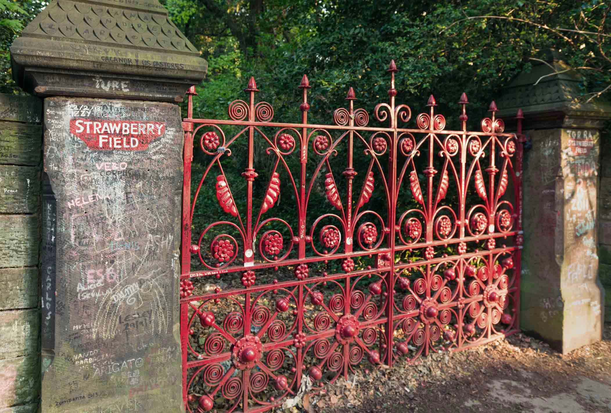 Liverpool, UK - Graffiti surrounding the famous red gates at the entrance to the historical Salvation Army Children's Home known as Strawberry Field, said to be John Lennon's inspiration for the 1966 song 'Strawberry Fields Forever' by The Beatles.