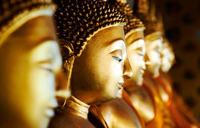 Profile photograph of a row of golden Buddhas at Wat Arun, Bangkok, Thailand.