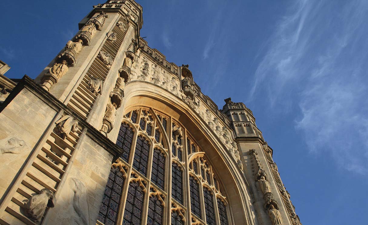 The Gothic Bath Abbey, shot looking up at the front face of the building.