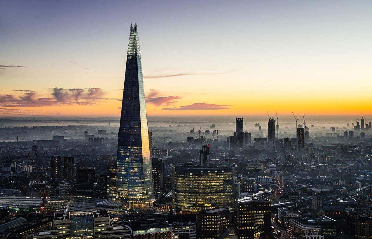 Picture of the Shard building in London, set against a morning sunrise.