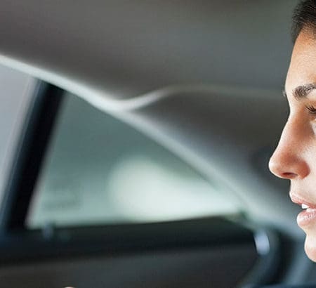 businesswoman travelling in a car looking through the window