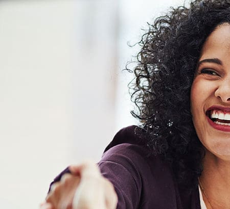 woman smiling giving a handshake