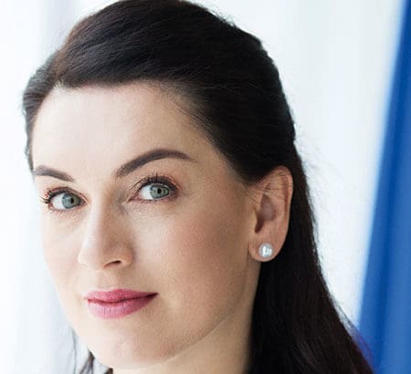 ambassador woman pausing in front of flags