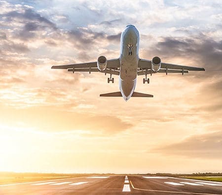 airplane taking off in sunset