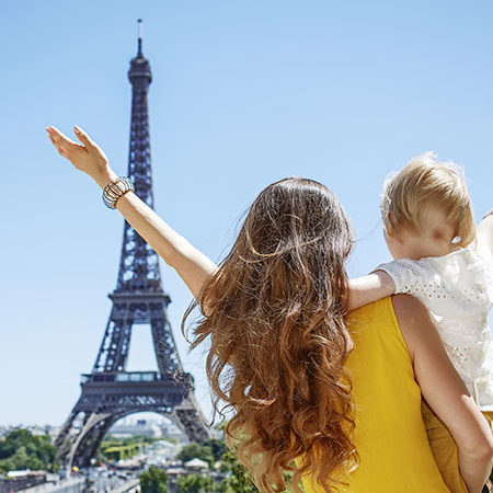 woman and child in front of the Eiffel tower