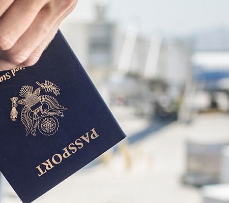 holding a passport in airport setting