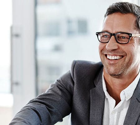 business man in suit smiling and shaking hand