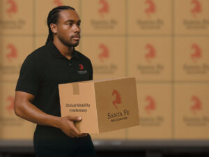 One of the Santa Fe Moving team carrying a box. With 60 years of experience, Santa Fe Relocation is your dedicated international mover in London. 